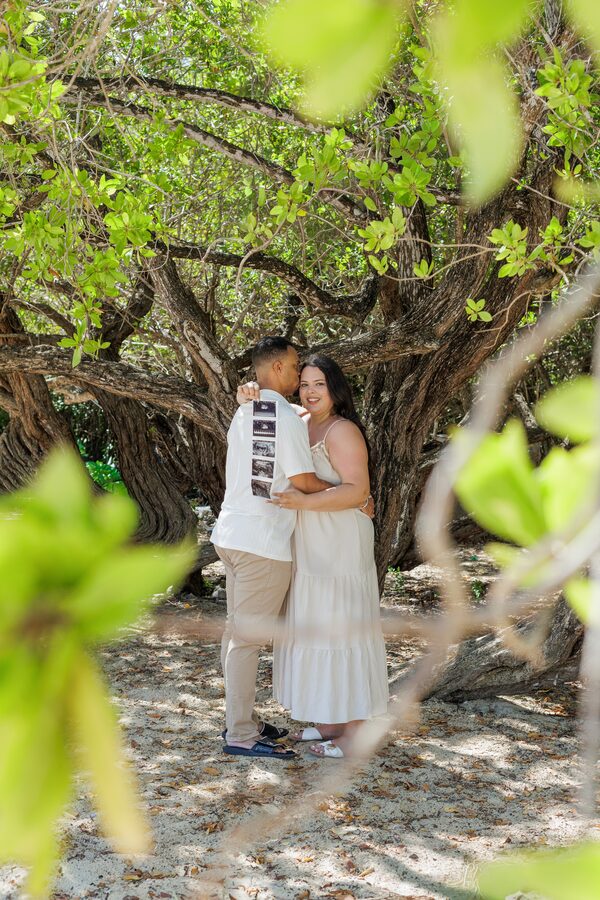 Parents-to-be holding their ultrasound photos